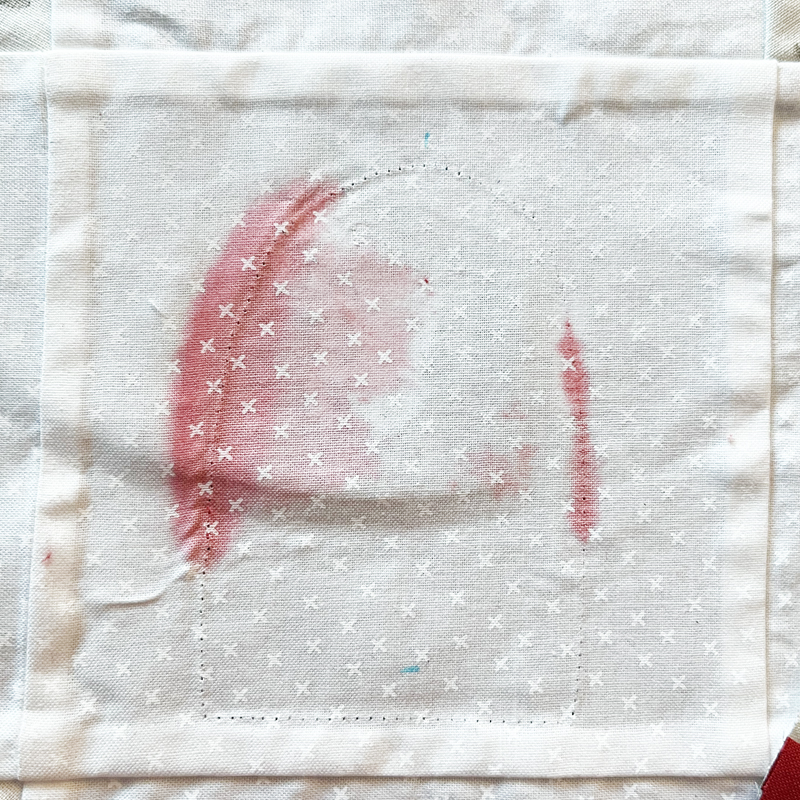 Fabric bled onto quilt block.